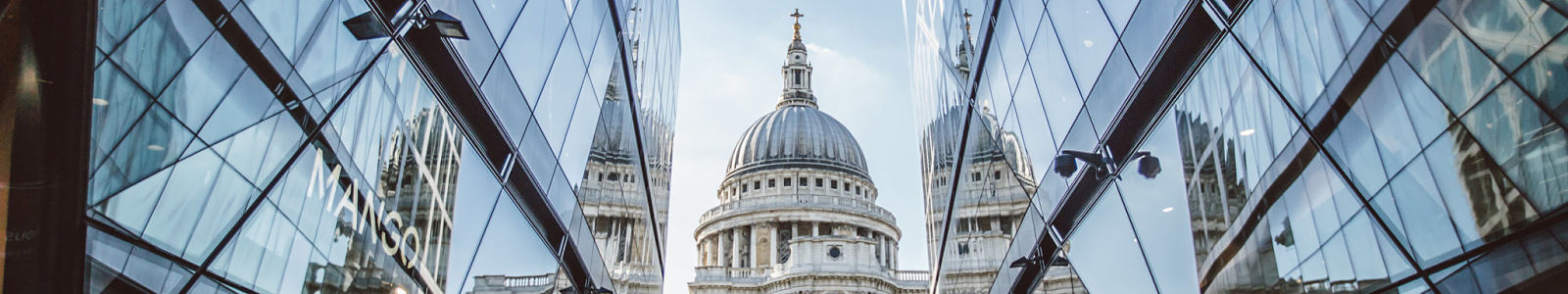 St Paul's cathedral's dome standing between two glass buildings