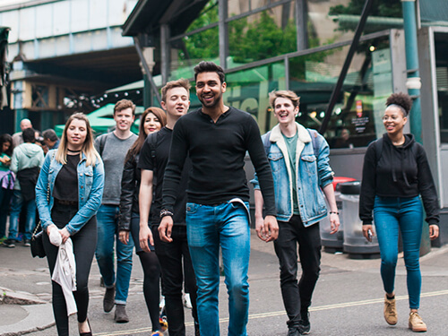 Group of students walking through London streets