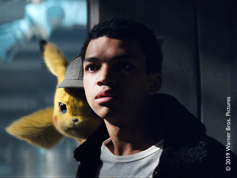 Animated Pikachu standing on a man's shoulder